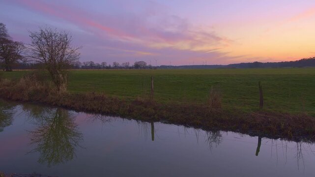 View along a ditch to a meadow landscape at sunset, Kirchlinteln, Verden, Aller Leine Valley, Lower Saxony, Germany