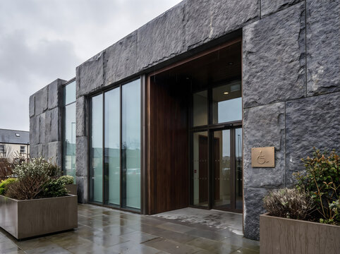 Modern public building entrance featuring hygienic anti microbial surfaces and sleek stone facade architecture