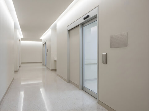 Modern hospital hallway interior featuring smooth surfaces, hygienic sliding doors, and clean corridor design