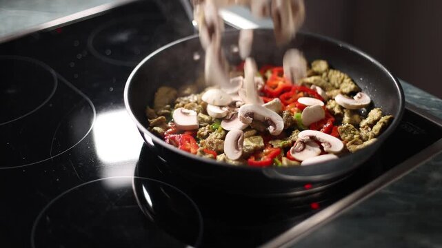 Mushrooms fall in pan on stove