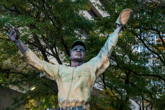 Jersey City, NJ - US - Oct 7, 2026 : A detailed view of the Jackie Robinson statue at Journal Square shows the baseball player in a Dodgers uniform holding a glove overhead with his arms outstretched.