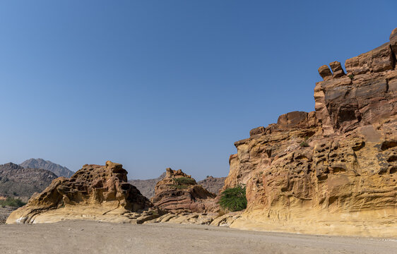 View of the rugged rock formations of the Sulaiman Mountains under a clear blue sky in De-excluded Area Dera Ghazi Khan, Punjab, Pakistan.