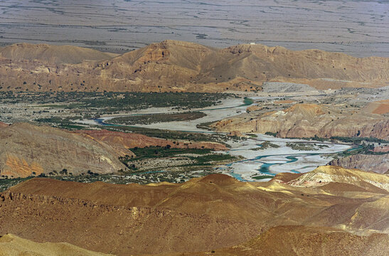 View of the Sulaiman Mountains with a winding river flowing through the arid landscape in De-excluded Area Dera Ghazi Khan, Punjab, Pakistan.