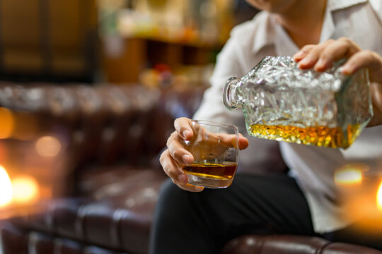 Closeup businessmen holding a glass of whiskey