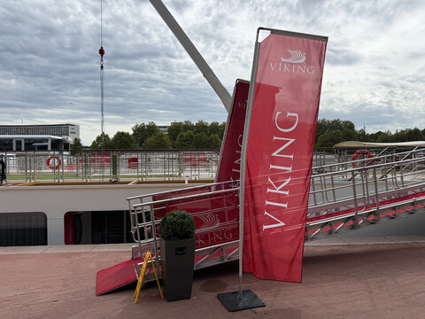 Red Viking Cruised banners stand beside a boarding gangway leading to a moored river cruise ship - Rouen, France - September 6, 2026
