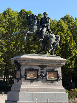 Equestrian statue of Napoleon I on a stone pedestal with gilded inscriptions, surrounded by trees beneath a clear blue sky - Rouen, France - September 6, 2026