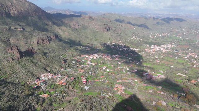 Aerial push in drone shot reveals El Rinc&oacute;n, a charming village nestled in a lush, rugged valley on Gran Canaria, Canary Islands, Spain.