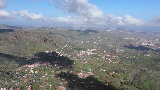 Aerial pull back drone shot reveals El Rinc&oacute;n, a charming village nestled in a lush, rugged valley on Gran Canaria, Canary Islands, Spain.