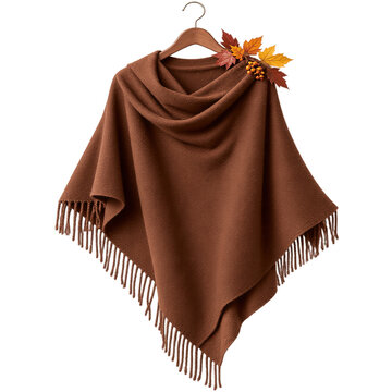 Brown wool shawl with fringe hanging on wooden hanger, decorated with autumn maple leaves and berries, isolated on transparent background. Fashion accessory, seasonal clothing, autumn style.