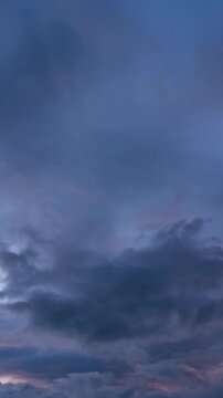 Ominous dark thunderclouds moving fast across the sky, impending rain storm time-lapse.