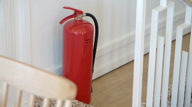 Fire extinguisher placed next to stairs in a building