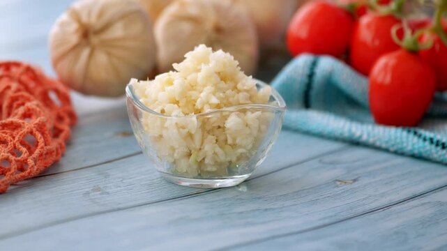 Cooking with fresh ingredients like tomatoes and garlic on a blue wooden table