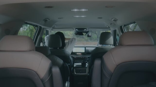 POV Shot from Backseat of Woman Stretching and Resting Inside Car during Road Trip