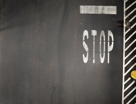 Close-up of road stop sign marking on pavement