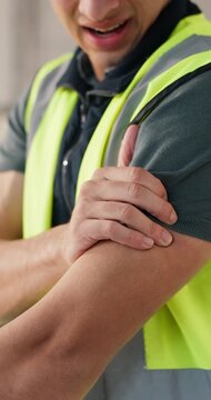Construction, massage and hands with shoulder pain, strain and labor injury on building site. Accident, man and engineer with arm issue, muscle tension and arthritis in infrastructure development.