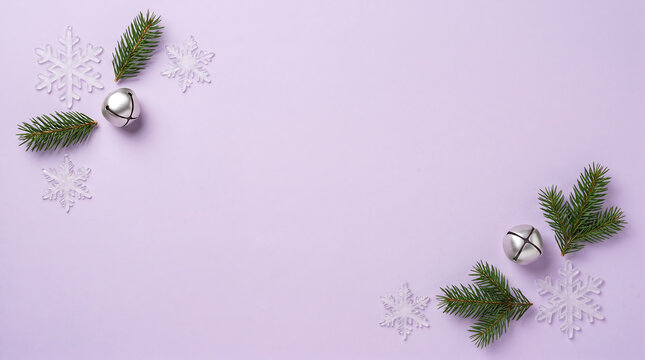Christmas background with silver bells white snowflakes and evergreen branches on a lavender surface
