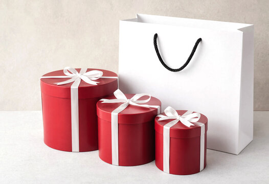 Three red gift boxes with white ribbon and shopping bag