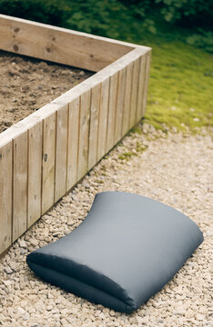Garden kneeling pad beside a raised bed