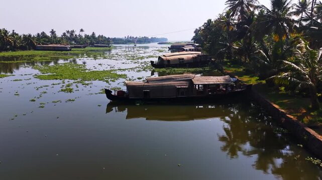 Drone flying over houseboats moored in the tropical canals of Kochi backwaters