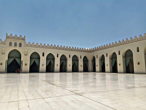 Courtyard of Al-Hakim Mosque in Cairo, Egypt with white marble floor and arched colonnades