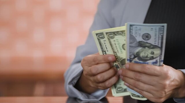 personal finances planning and household finances concept. woman is counting dollar money.
