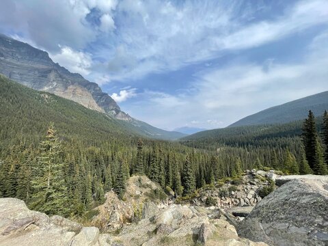 Alpine valley with evergreen forest and rocky slopes near Moraine Lake, Banff National Park, Alberta, Canada