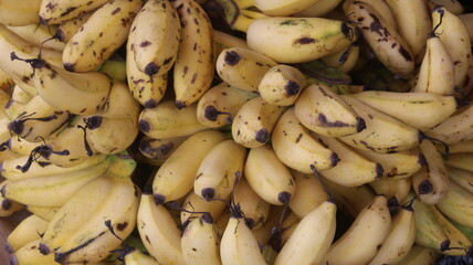 Fresh Ripe Yellow Bananas with Natural Brown Spots, Close-Up Tropical Fruit Background  © Fresh Foods