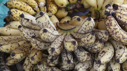 Fresh Ripe Yellow Bananas with Natural Brown Spots, Close-Up Tropical Fruit Background  © Fresh Foods