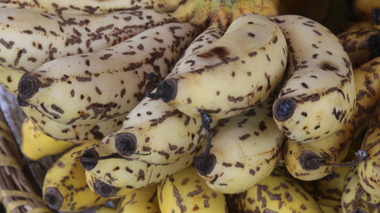 Fresh Ripe Yellow Bananas with Natural Brown Spots, Close-Up Tropical Fruit Background  © Fresh Foods