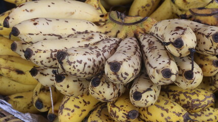 Fresh Ripe Yellow Bananas with Natural Brown Spots, Close-Up Tropical Fruit Background  © Fresh Foods