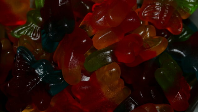 Close-up of colorful gummy worms candy sweet dessert snack macro background