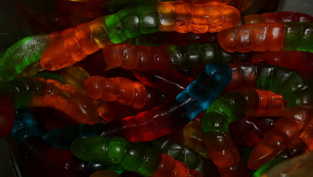 Close-up of colorful gummy worms candy sweet dessert snack macro background