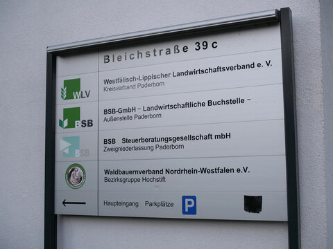 Germany, Paderborn, October 08. 2026, multi-panel building directory sign at Bleichstra&szlig;e 39c in Paderborn, listing agricultural and tax associations including "WLV", "BSB-GmbH", "BSB Steuerberatungsg