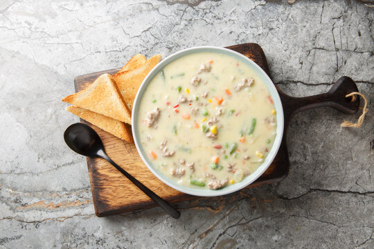Shepherd's Pie Soup has lean ground beef, veggies and seasonings simmered in a delicious cream stock closeup on the plate on the table. Horizontal top view from above