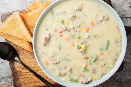 Close-up of shepherd's pie soup with mashed potatoes, ground beef, vegetables, and spices in a bowl on a table. horizontal top view from above