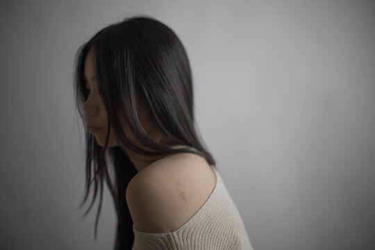 Thoughtful Southeast Asian woman portrait with long black hair