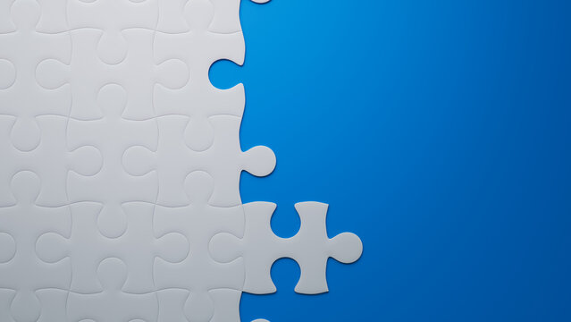 Partially Completed Blue and White Jigsaw Puzzle Backdrop with copy-space. Building Concept.