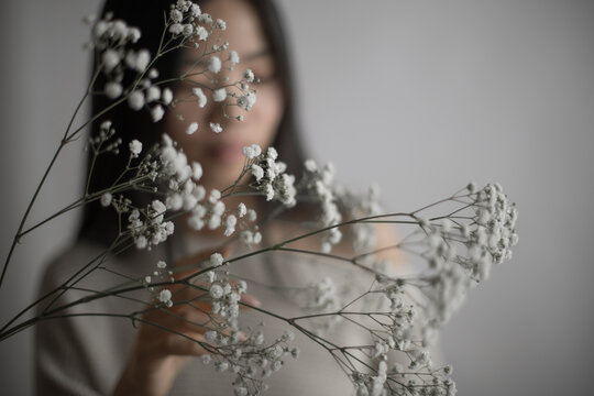 Portrait of Southeast Asian woman holding delicate white baby's breath