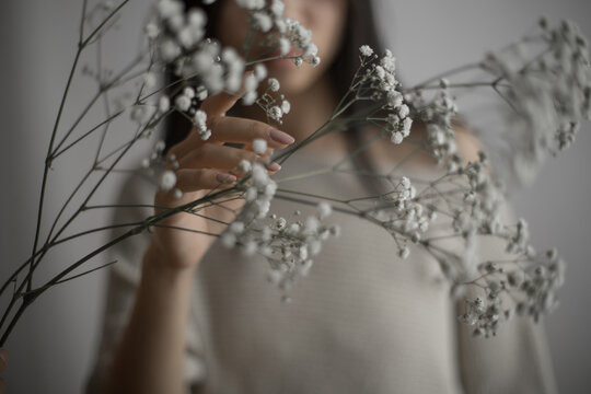 Southeast Asian woman holding delicate baby's breath flowers