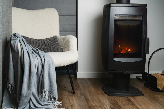 Cozy space with a chair and a stove creating a warm atmosphere