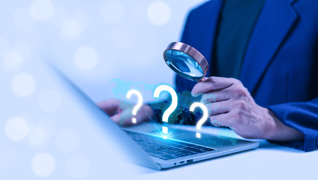 Business professional examining digital question marks with a magnifying glass over a laptop and global network, representing online research, data analysis, problem solving, business intelligence.