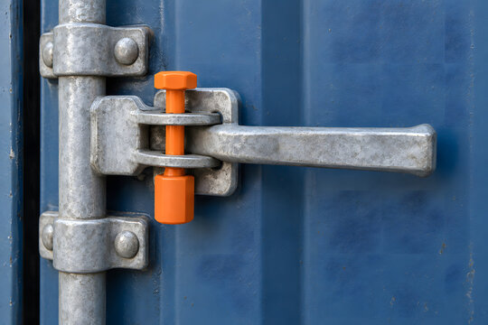 Orange tamper-evident bolt seal securing a shipping container door