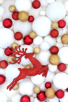 Christmas red reindeer sparkling tree decorations with sphere shape balls background. Festive symbols for the holiday season greeting card.