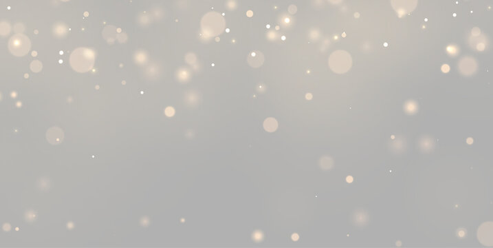 Glowing golden bokeh lights drift softly across a dark background. The circular light spots vary in size and intensity creating a warm, dreamy atmosphere.