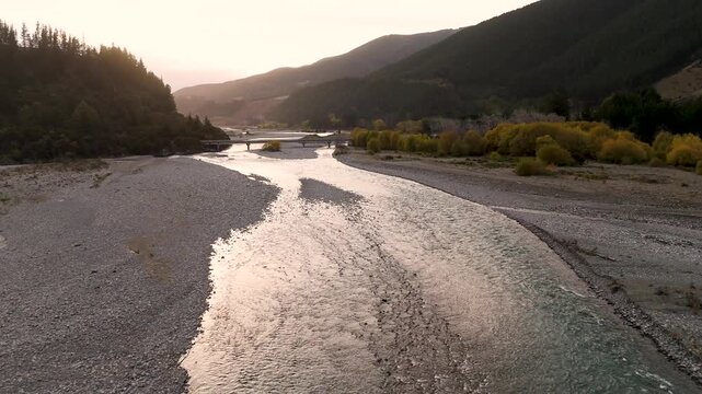 Drone Flying Toward Wash Bridge Over Wairau River at Sunset