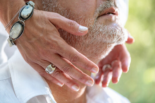 Holding hands around the neck and throat area during a spiritual chakra balancing practice focused on energy flow, mindfulness, emotional harmony, and wellbeing.