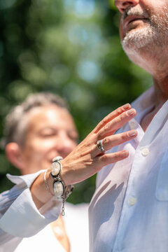 Practitioner performing a heart-centered energy gesture during guided chakra balancing, symbolizing emotional harmony, spiritual awareness, mindfulness, and holistic healing.