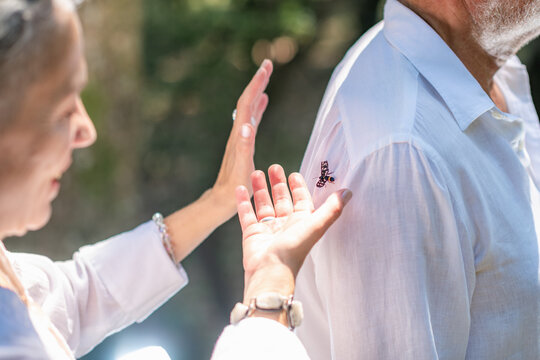 Hands positioned around the upper body during a chakra balancing practice, representing focused energy work, spiritual connection, emotional harmony, and guided meditation.
