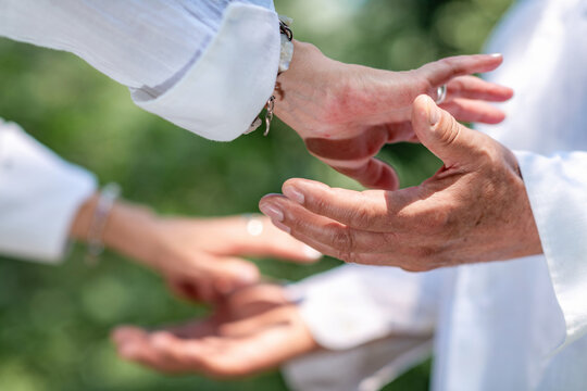Open hands facing each other during a spiritual healing practice, representing energy exchange, chakra balancing, mindfulness, emotional connection, and holistic wellbeing.
