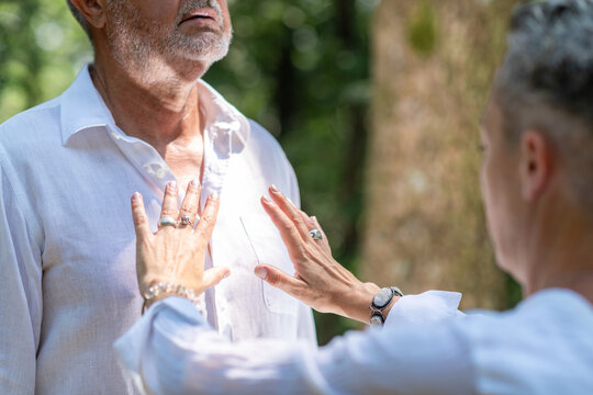 Holding hands near the heart center during a guided chakra healing practice, symbolizing emotional balance, spiritual awareness, energy flow, and mindful connection.